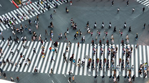 People walking over two crossings