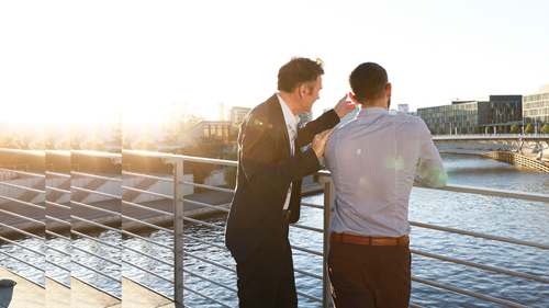 Two businessmen on a bridge family offices and private clients