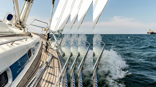 Sailboat and container ship