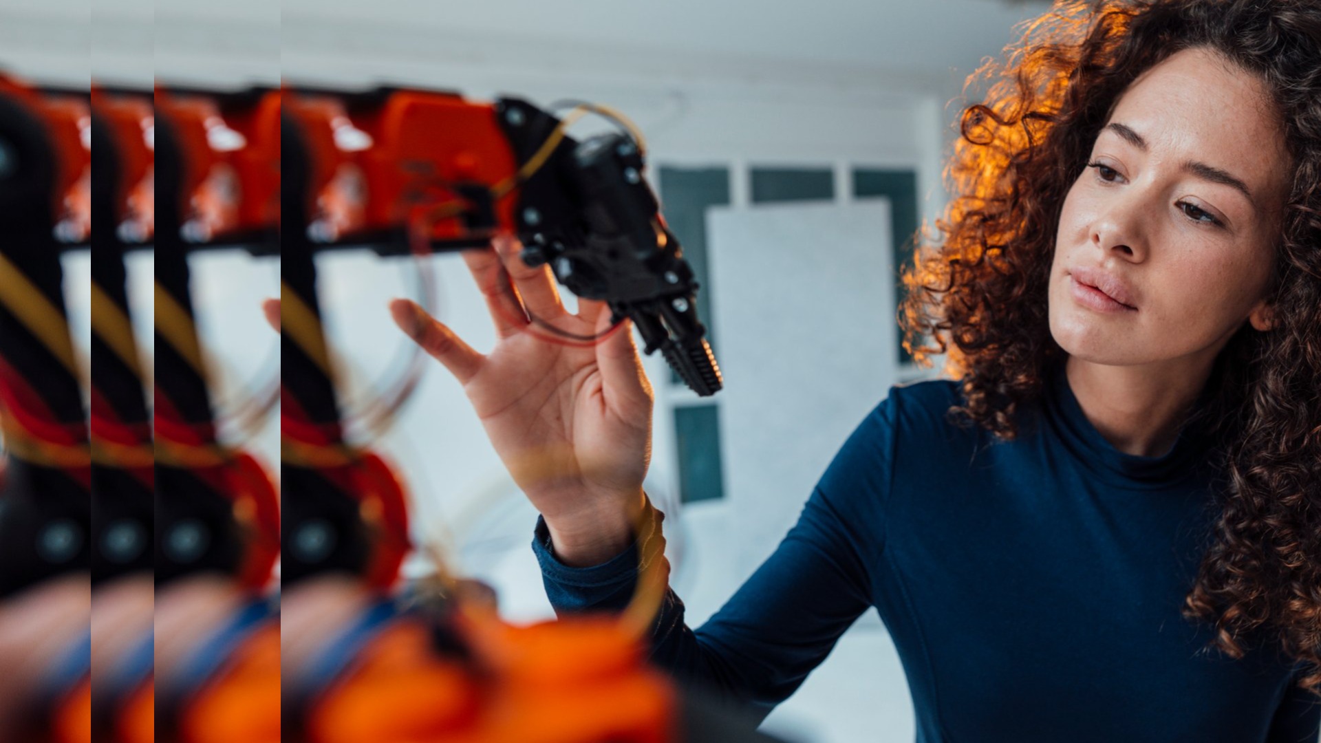 Engineer examining robotic arm pulsed