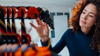 Engineer examining robotic arm pulsed