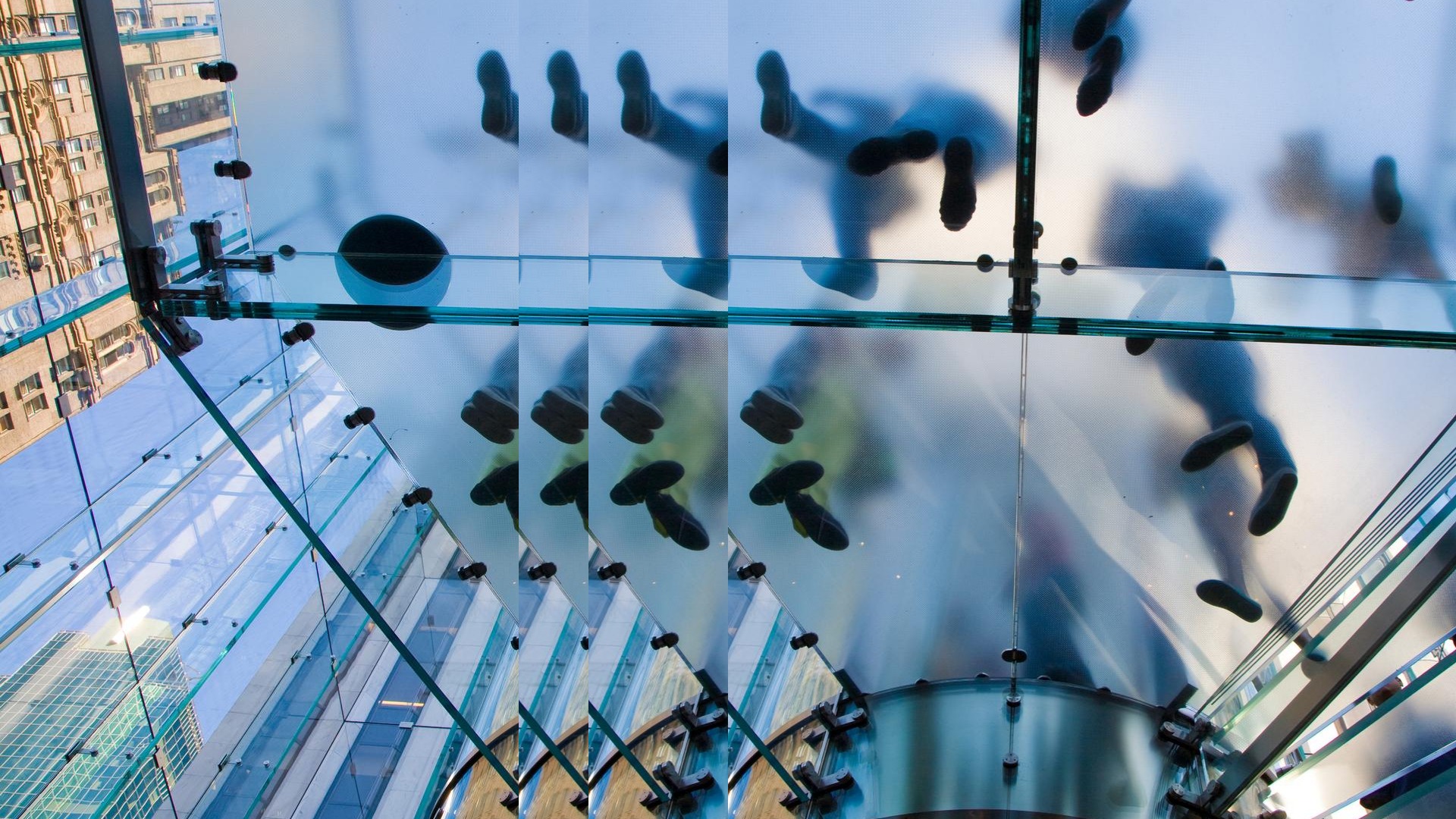 people on glass staris