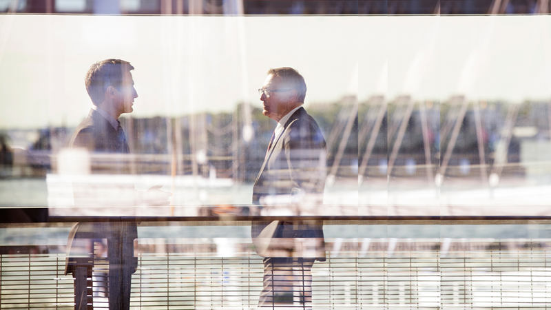 Two men talking outside