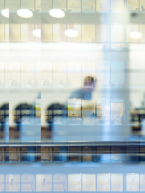 people working late in office blurred corporate