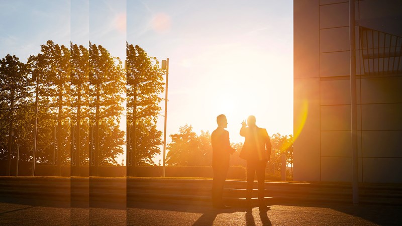 silhouette two businessmen in the sunset partner